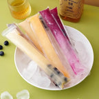 Four filled disposable popsicle bags held in hand showing sealed and sturdy design