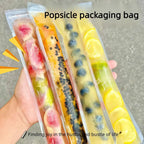 Colorful fruit popsicles in disposable bags on ice plate — lifestyle shot